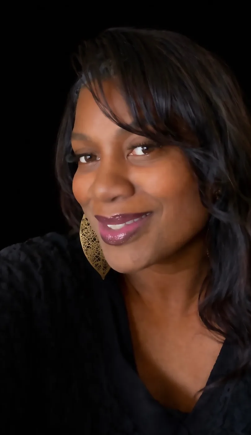 Portrait of Samantha Scott, founder of MAACC CIC, against a black background